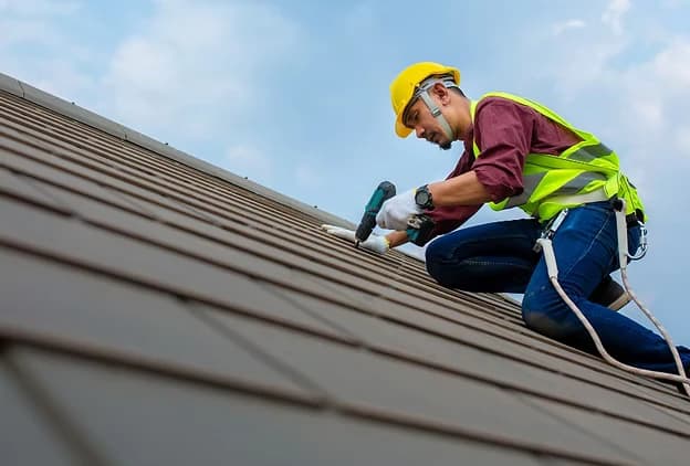 Roofing worker on roof