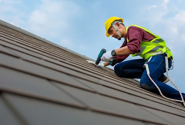 Roofing worker on roof